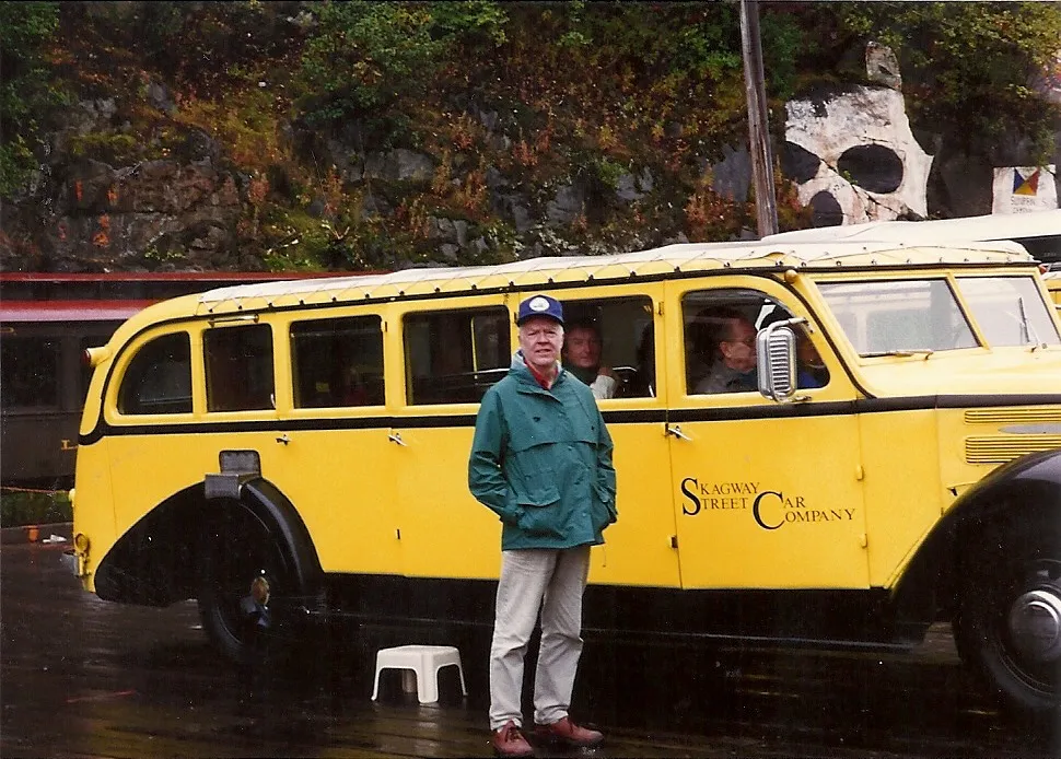 Phillip Shoultz in 1994 in front of a yellow vintage White bus in Skagway, Alaska